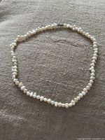 Choker necklace laid out showing full strand and pearls
