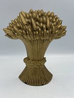Front view of gold-tone cast iron sheaf of wheat doorstop