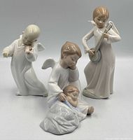 All three porcelain angel figurines grouped