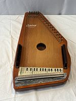 Full view of autoharp front showing strings, soundhole and chord bars