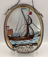 Front view of oval painted glass plaque on stand