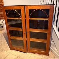Front view of wooden bookcase showing glass doors and interior shelves