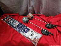 Packaged US flag set beside two mosaic solar garden stake lights