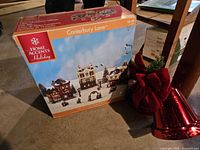 Original box for Canterbury Lane Christmas village set and red metal bell