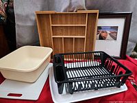 Group view showing dish rack, dishpan, grey drain board, bamboo organizer, framed photograph