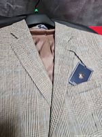 Close view of blazer front showing plaid pattern and hang tag