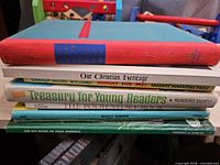 Stack of four children’s books showing spines and titles