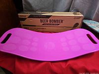 Pink balance board and Beer Bomber box together