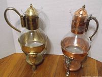 Front view of both glass carafes on stands