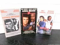 Front view of three VHS slipcases showing titles and artwork