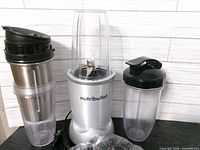 Front view showing motor base, cups and lids