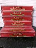 Six red Play-Rite boxes stacked horizontally