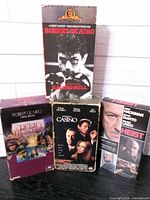 Front view of four VHS boxes: Raging Bull, The Deer Hunter, Casino, Heist