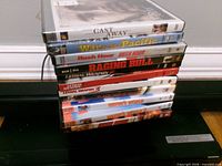 Stack of DVDs on top of Sony Blu-ray player