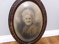 Front view of framed portrait showing convex glass and woman image