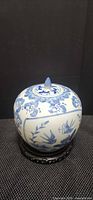 Front view of blue & white porcelain ginger jar on stand
