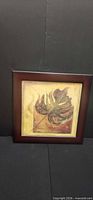Front view of framed leaf painting