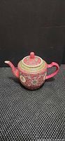 right side view of pink Chinese famille-rose teapot with lid