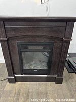 Front view of dark espresso freestanding electric fireplace with black insert