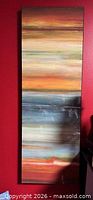 Full view showing tall, narrow framed abstract canvas with horizontal color bands