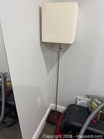 Full view of floor lamp showing rectangular shade, brushed nickel pole and square base