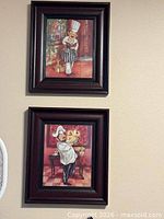 Both framed chef prints hung on wall showing artwork and frames