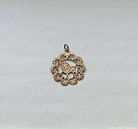 Front view of 10K gold Leo zodiac pendant