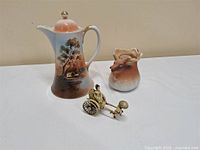 Full lot showing cocoa pot, rickshaw figurine, elk vase