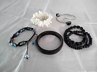 All seven bracelets arranged on table