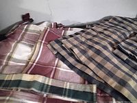 Stacked wine/white/green plaid curtains with blue/beige curtains alongside