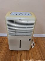 Front view of Premiere dehumidifier showing grille, reservoir slot and overall condition