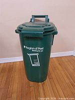 Front view of green Region of Peel organics bin