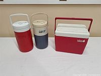 Full view of Igloo cooler and two Coleman jugs