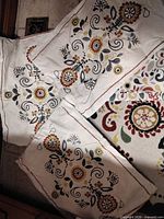 Close view of floral pillowcases and corner of matching rug
