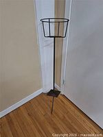 Full view of metal plant stand showing overall form and height