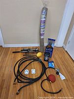 All items overview: burlap roll, hoses, timers, lantern, BBQ tools, pump, repellent, twine