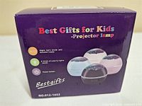 Front of sealed Bestgifts projector lamp box showing product images and features