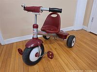 Full view of red Radio Flyer tricycle showing seat, wheels and frame