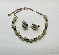 Full view of necklace with matching earrings displayed