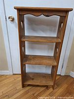 Front view of narrow wooden shelving unit