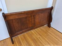 Full view of sleigh headboard front, showing panels and finish