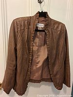 Front view of Tanjay brown faux-leather jacket on hanger