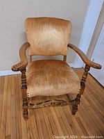 Full view of vintage wooden armchair with upholstery