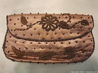 Full view of bronze satin beaded clutch front