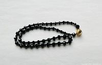 Necklace coiled showing full strand and clasp