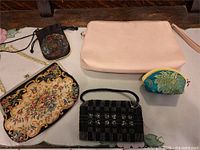 Group shot of all five handbags and pouches