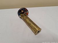 Full view of brass kaleidoscope showing tube and glass wheel