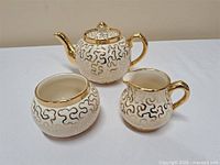 Teapot, creamer, sugar bowl front view