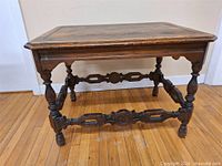 Full view of rectangular wood end table showing top, legs and stretchers