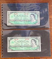 Two 1967 Canadian $1 notes in plastic sleeve, full view
